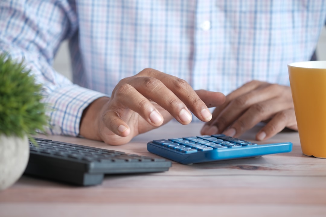 Business owner calculating ecommerce payment processing costs and fees
